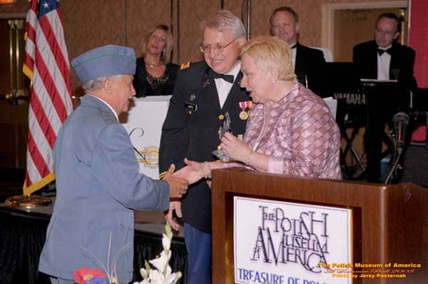 Albert Leca receiving the Polish Spirit Award on behalf of SWAP Post #1 from PMA Pres. Maria Ciesla as PMA Director Jan Lorys looks on. Pol-Am Veteran Organizations were honored with the award this year. Photo: Jerzy Pasternak